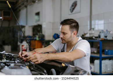 Close up of a mechanic working on car diagnostic in a repair shop - Shutterstock ID 1524494525