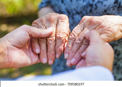 Close Up Medical Doctor Holding Senior Woman's Shaking Hands, Parkinson Disease