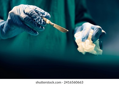 Close up of medical expert using scalpel during surgery in operating room.  - Powered by Shutterstock