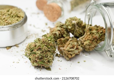 Close Up Of Medical Marijuana Buds , Crusher , Glass Bottles, White Background