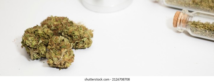 Close Up Of Medical Marijuana Buds , Crusher , Glass Bottles, White Background