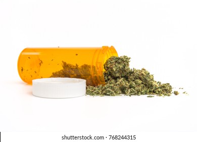 Close Up Of Medical Marijuana In Yellow Pill Bottle On White Background