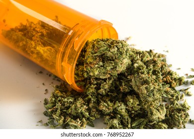 Close Up Of Medical Marijuana In Yellow Pill Bottle On White Background