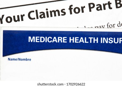 Close Up Of Medicare Health Insurance Card And Claims Statement Isolated On White