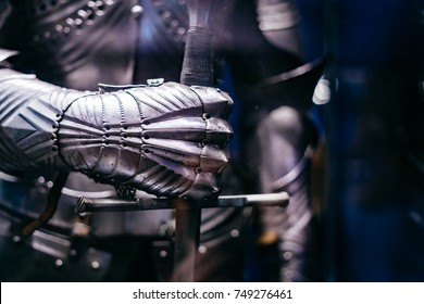 Close up of a Medieval steel armour with hand holding a giant sword - Shutterstock ID 749276461