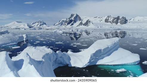 Close up melting iceberg on waters of Southern Ocean to ice-shelves, glaciers and mountains aerial. Distinct natural environments of Antarctica. Changing climate and global warming problem, rising sea - Powered by Shutterstock