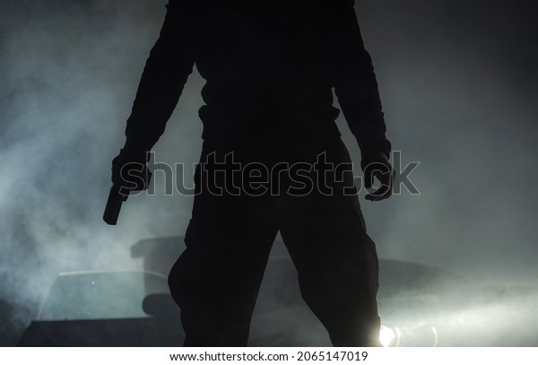 Close Up of Men with Gun Who Committing Crime\
During Night Hours. Outlaw Concept.\

