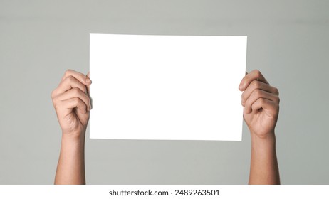 Close up of  men hands holding the white blank paper isolated on grey white background. Mockup for design  - Powered by Shutterstock