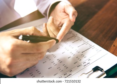 Close Up Of Men Hands Using Lancet On Finger To Check Blood Sugar Level By Glucose Meter On Chart Background.(vintage Tone)