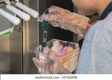 Close Up Of Men's Hand Holding Kitchen Thermometer And Measuring Ic Cream Temperature
