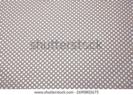 Close up of the mesh fabric pattern from the backrest of the chair.