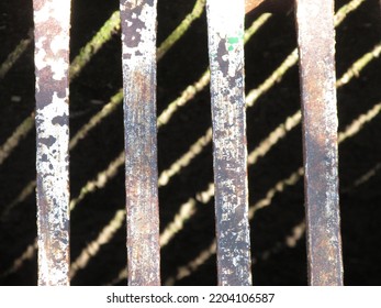 A Close Up Of Metal Bars On A Storm Water Grate