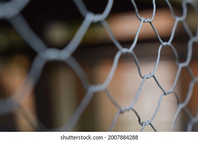 close up of metal chicken wire. blured background.