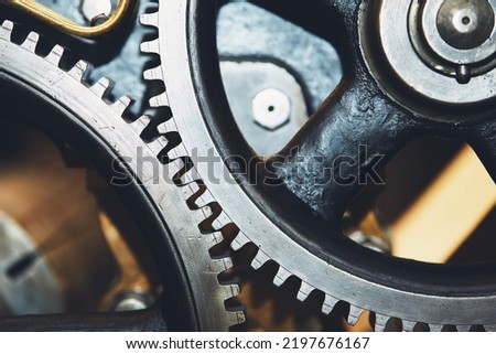 Close up of metal cog wheel in engine of machine.