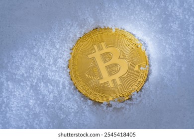 Close up of metal golden bitcoin crypto currency coin the background of white snow in winter. Electronic decentralized money concept. Frozen bitcoin - Powered by Shutterstock