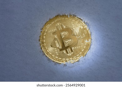 Close up of metal golden bitcoin crypto currency coin the background of white snow in winter. Electronic decentralized money concept. Frozen bitcoin - Powered by Shutterstock