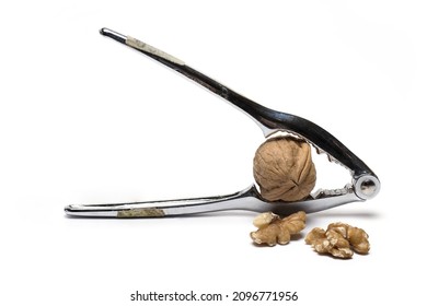 Close up of metal pliers to open nuts with walnut nutcracker isolated on white background