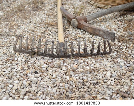 Close up of metal rake on gravel