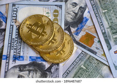 Close up of metal shiny bitcoin crypto currency coins on US dollar bills. Electronic decentralized money concept.