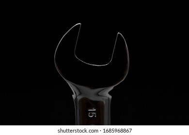 Close Up Of Metal Spanner Rim Lit In Black Background