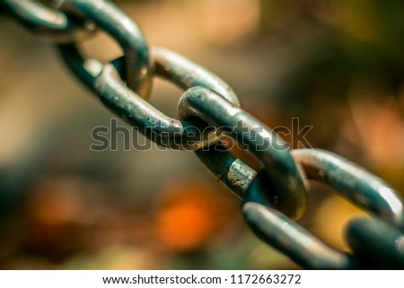 Close up to a metallic chain on a colorful blurred background. Modern concept idea