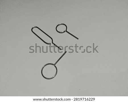 Close up of metallic SIM tray eject pin needles for smartphones