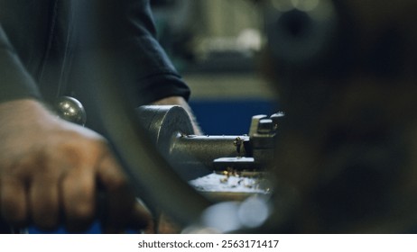Close up of a metalworker operating a lathe machine, shaping metal parts in a factory setting, demonstrating industrial manufacturing processes and skilled craftsmanship