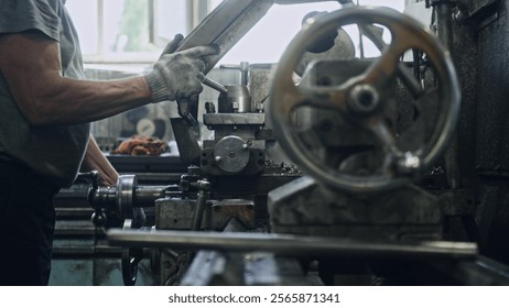 Close up of a metalworker operating a lathe machine, shaping metal components with precision and expertise in a bustling workshop environment