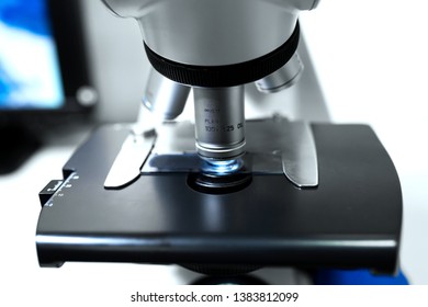 Close up microscope lens on gray background.