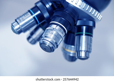 Close up of microscope lenses with soft focus on bright background