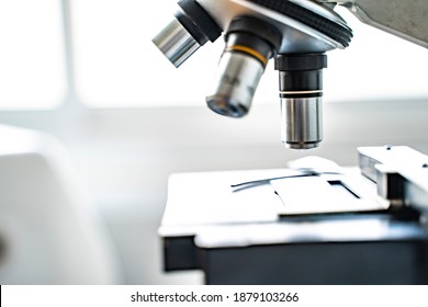 Close Up Microscope Stage And Objectives Researching Corona Virus Microscopic Cells Behavior Testing Vaccination Cure, In Medical Center Lab China Wuhan World Health Organization Research Facilities