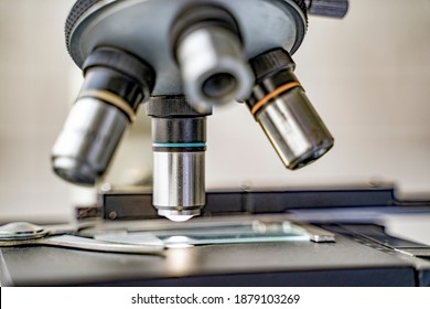 Close Up Microscope Stage And Objectives Researching Corona Virus Microscopic Cells Behavior Testing Vaccination Cure, In Medical Center Lab China Wuhan World Health Organization Research Facilities