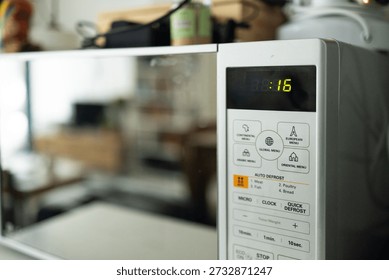 Close up of microwave oven control panel in modern kitchen, household appliance detail and everyday cooking concept