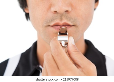 Close Up Mid Section Of Referee Blowing Whistle On White Background