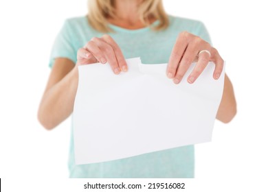Close up mid section of woman holding torn sheet of paper over white background