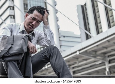 Close Up Middle Aged Asian Businessman Feeling Stress And Depressed When He Jobless From Company Laid Off Problems. Economic Recession Effect Concept, Copy Space.