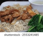 Close up Mie ayam teriyaki Solaria, Noodles with chicken teriyaki, chicken teriyaki, fried dumpling and vegetables is Indonesia popular food