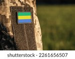 Close up millitary woman or man shoulder arm sleeve with Gabon flag patch. Gabon troops army, soldier camouflage uniform. Armed Forces, empty copy space for text

