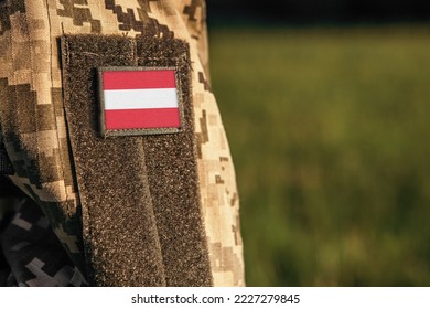 Close up millitary woman or man shoulder arm sleeve with Austria flag patch. Austria troops army, soldier camouflage uniform. Armed Forces, empty copy space for text

 - Powered by Shutterstock