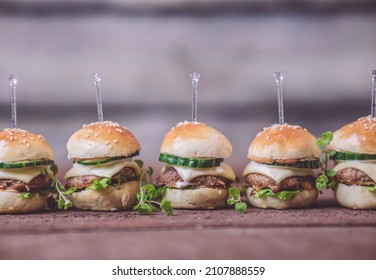 Close Up Of Mini Beef Burgers Isolated On Wood Background