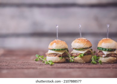 Close Up Of Mini Beef Burgers Isolated On Wood Background