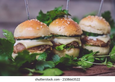 Close Up Of Mini Beef Burgers Isolated On Wood Background