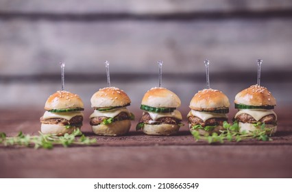 Close Up Of Mini Beef Burgers Isolated On Wood Background