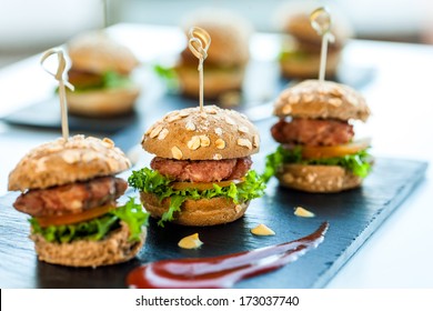 Close up of mini hamburgers at catering event.