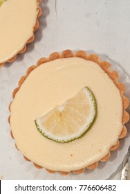 Close Up Of A Mini Key Lime Pie With A Slice Of Lime On Display, For Sale At A Tropical, Open Air  Farmrs Market
