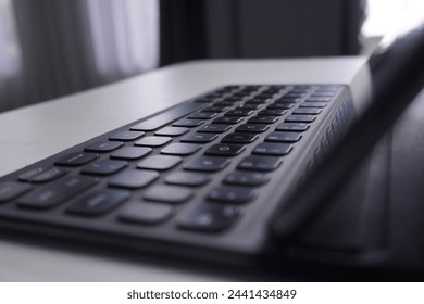 close up of a mini keyboard and tablet screen on white table