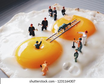 Close Up Miniature People Explorer Fall In Yolk Then The Team Trying To Helping.