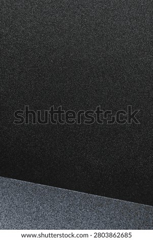 Close up of a minimalist black surface featuring smooth texture and clean geometric lines. Showcasing modern simplicity, architectural details, and elegant abstract composition, ideal for interior design, contemporary backgrounds, and creative layouts.