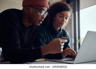 Close Up Of Mixed Race Couple Using Laptop For Online Shopping. Happy African American Couple Using Credit Card For Online Banking. High Quality Photo