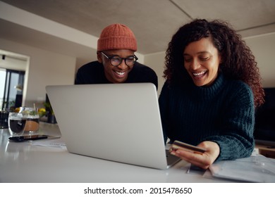 Close Up Of Mixed Race Couple Using Laptop For Online Shopping. Happy African American Couple Using Credit Card For Online Banking. High Quality Photo